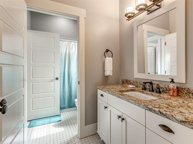 bathroom featuring toilet, a shower with curtain, vanity, and tile patterned floors