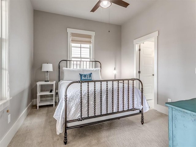 bedroom featuring light colored carpet and ceiling fan