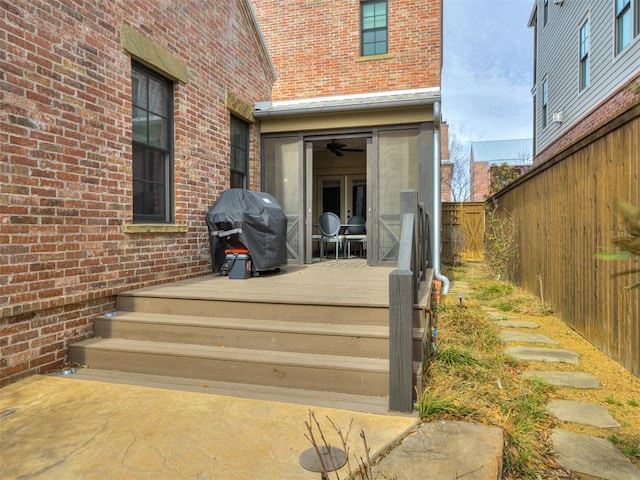 view of exterior entry featuring a wooden deck