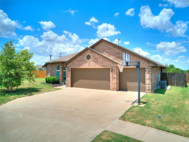 view of front of home featuring a front lawn and central AC