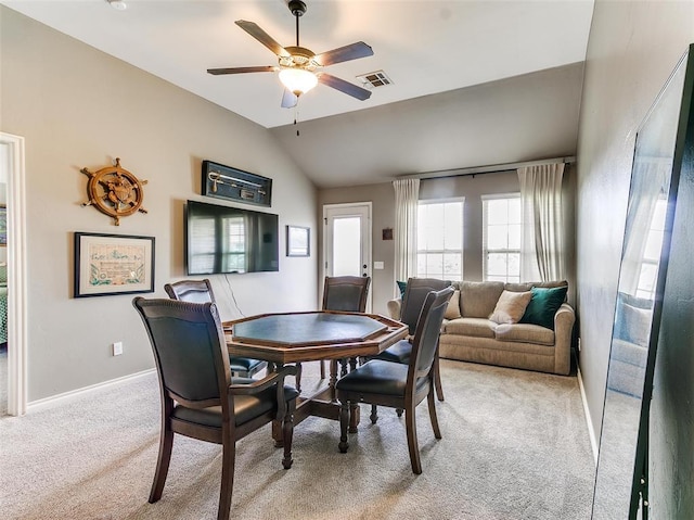 dining space featuring vaulted ceiling, ceiling fan, and light colored carpet