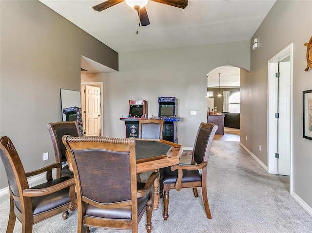 dining space with light carpet and ceiling fan