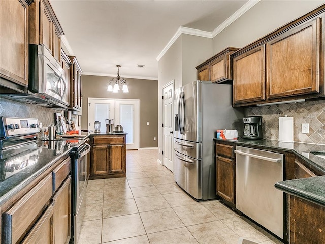 kitchen featuring light tile patterned floors, appliances with stainless steel finishes, a notable chandelier, ornamental molding, and pendant lighting