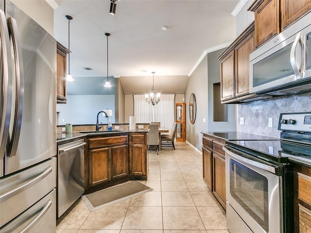 kitchen with decorative light fixtures, stainless steel appliances, ornamental molding, a notable chandelier, and light tile patterned floors