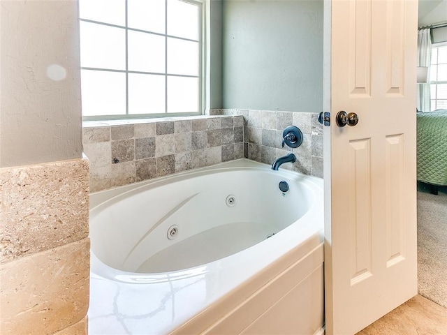 bathroom featuring a tub and plenty of natural light