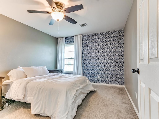 bedroom featuring ceiling fan and light carpet