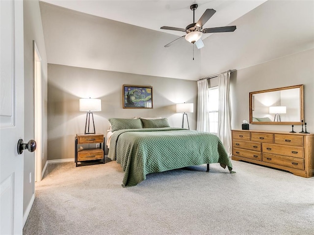 bedroom with ceiling fan, vaulted ceiling, and carpet flooring