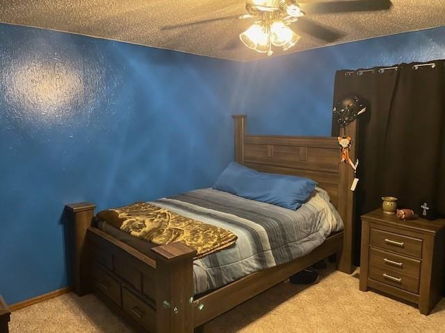 carpeted bedroom featuring ceiling fan and a textured ceiling