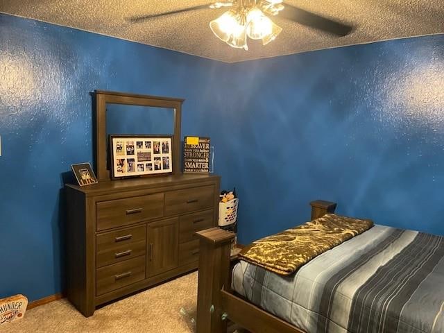 carpeted bedroom with a textured ceiling and ceiling fan