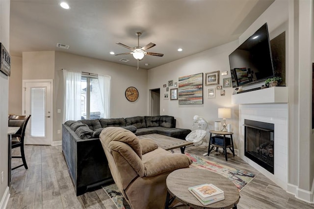 living room featuring ceiling fan and hardwood / wood-style floors