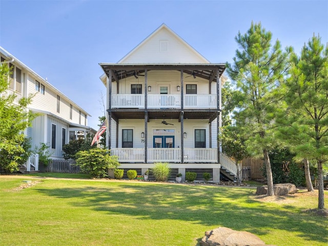 view of front of home with covered porch, a front lawn, a balcony, and ceiling fan