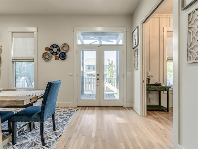 doorway to outside featuring plenty of natural light, light hardwood / wood-style flooring, and french doors