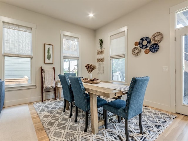 dining space with hardwood / wood-style floors