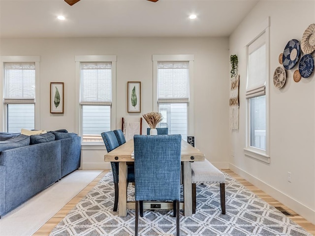 dining room featuring plenty of natural light and light hardwood / wood-style flooring