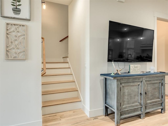 stairs featuring hardwood / wood-style floors