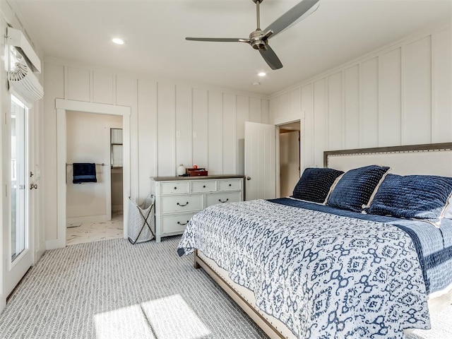 carpeted bedroom featuring ceiling fan and connected bathroom