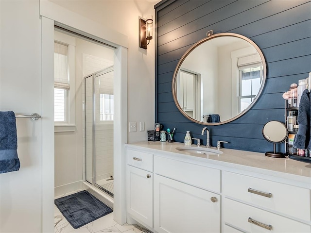 bathroom featuring vanity, an enclosed shower, and wooden walls