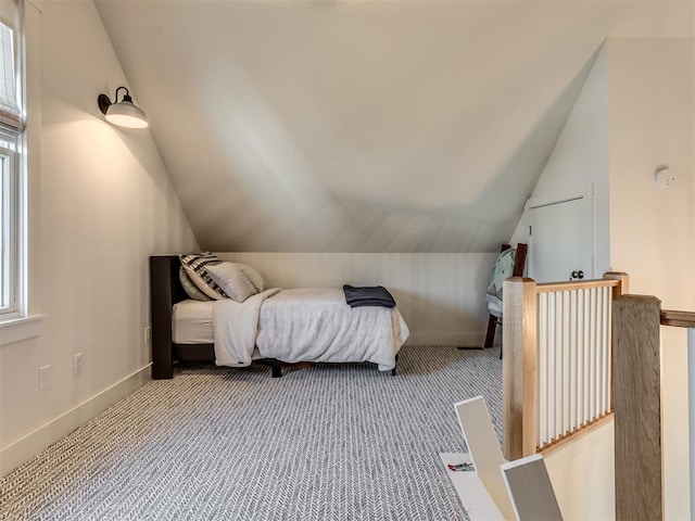 carpeted bedroom featuring vaulted ceiling