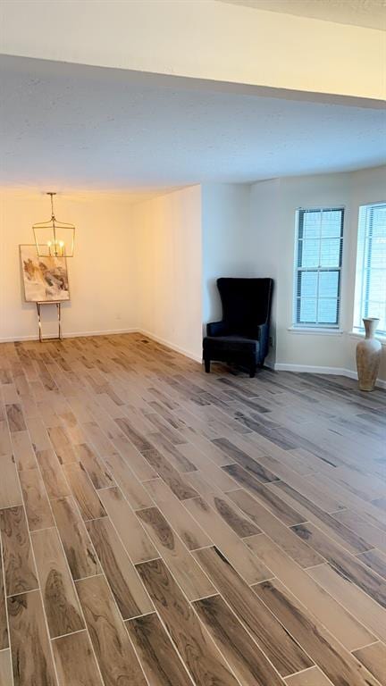 interior space with hardwood / wood-style flooring and an inviting chandelier