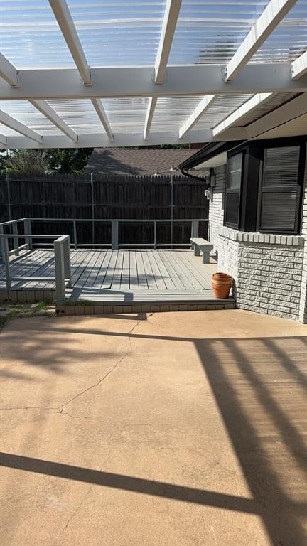 view of patio featuring a pergola and a deck