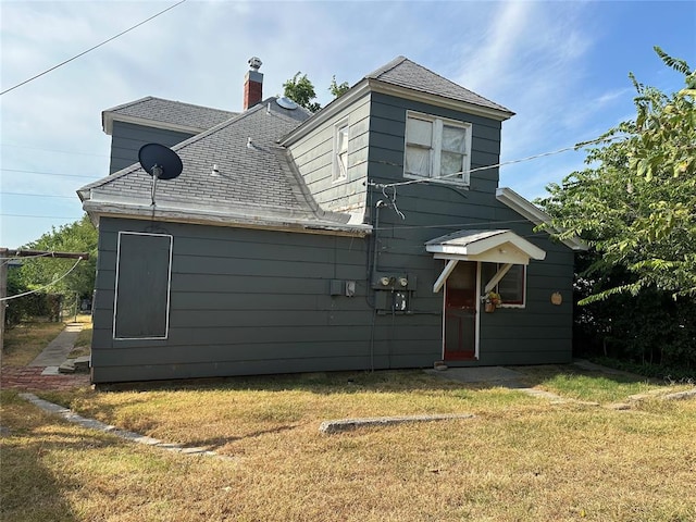 back of house with a lawn