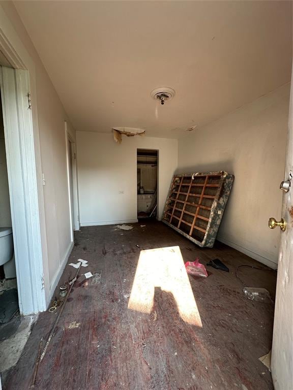 unfurnished bedroom featuring dark wood-type flooring