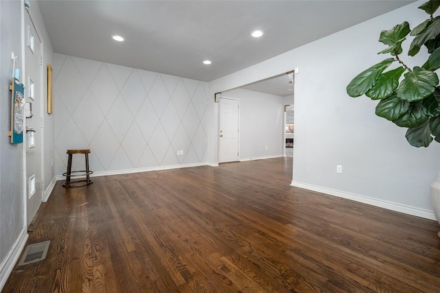 unfurnished room with dark hardwood / wood-style flooring and tile walls