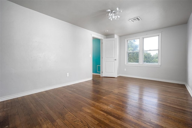 spare room with dark hardwood / wood-style flooring