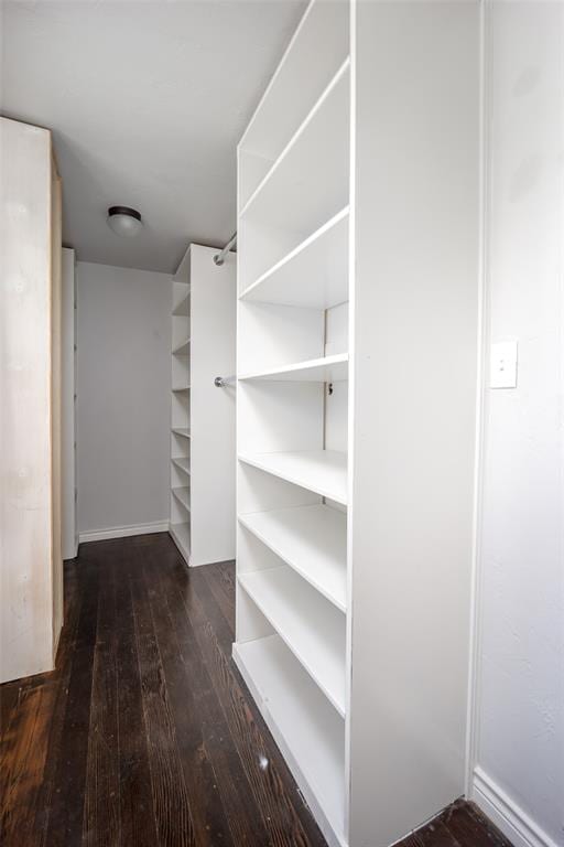 walk in closet featuring dark wood-type flooring