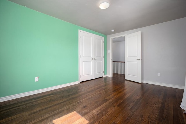 unfurnished bedroom featuring dark hardwood / wood-style flooring