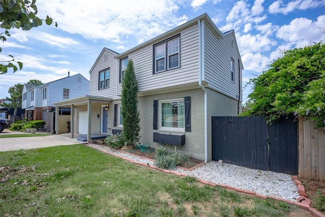 view of front of home with a garage and a front lawn