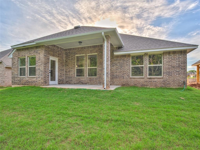 exterior space featuring a lawn and a patio area