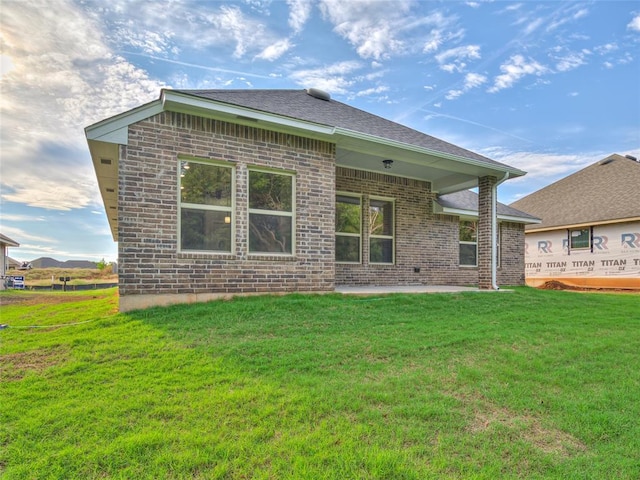 rear view of house with a yard