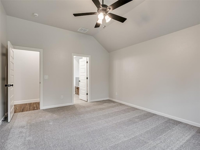 unfurnished bedroom with connected bathroom, ceiling fan, light carpet, and lofted ceiling