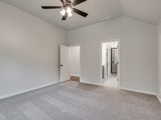 unfurnished bedroom with ceiling fan, lofted ceiling, and light carpet