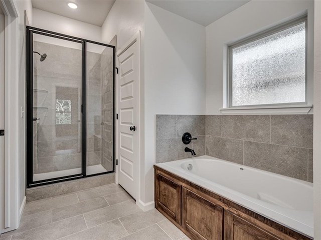 bathroom with tile patterned flooring and separate shower and tub