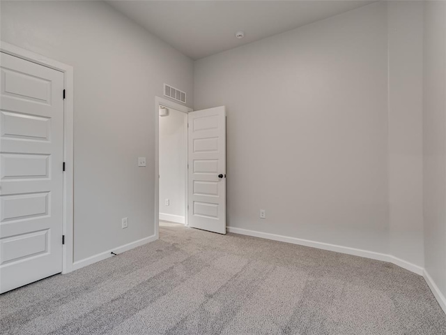 empty room featuring light colored carpet