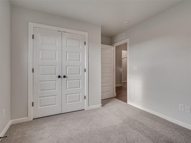 unfurnished bedroom featuring carpet and a closet