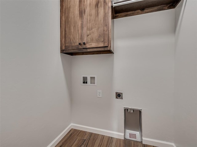 washroom featuring hookup for an electric dryer, hookup for a washing machine, cabinets, and wood-type flooring