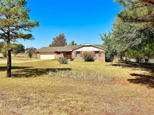 ranch-style home featuring a front yard and a garage