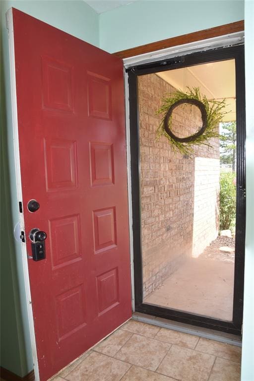 doorway with light tile patterned flooring