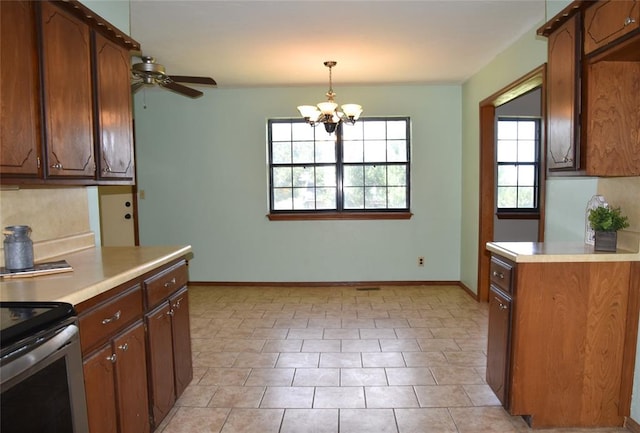 kitchen featuring pendant lighting, ceiling fan with notable chandelier, and light tile patterned floors