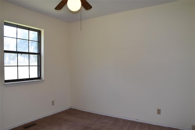 carpeted empty room featuring ceiling fan