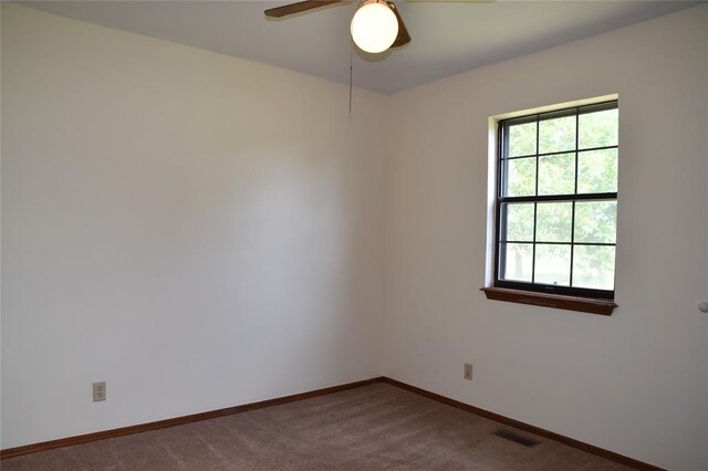 empty room featuring carpet and ceiling fan