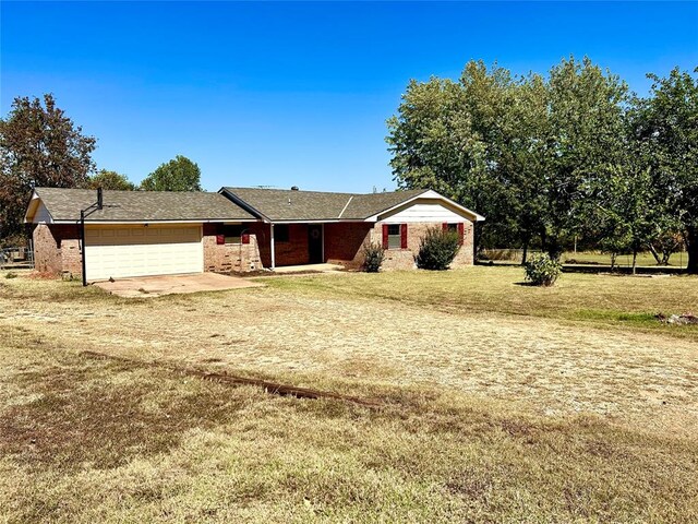 ranch-style house with a garage and a front yard