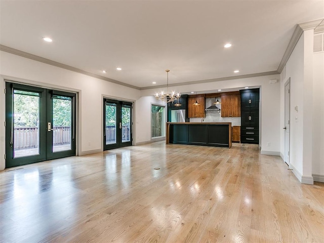 kitchen featuring a center island, a healthy amount of sunlight, light wood-type flooring, and french doors