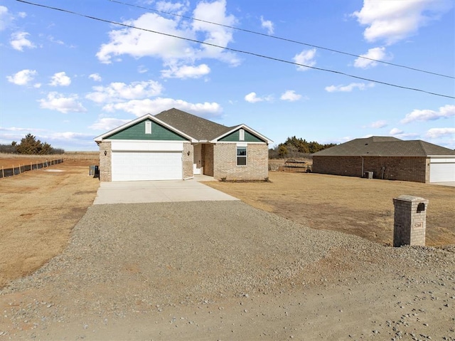 view of front of property with a rural view and a garage