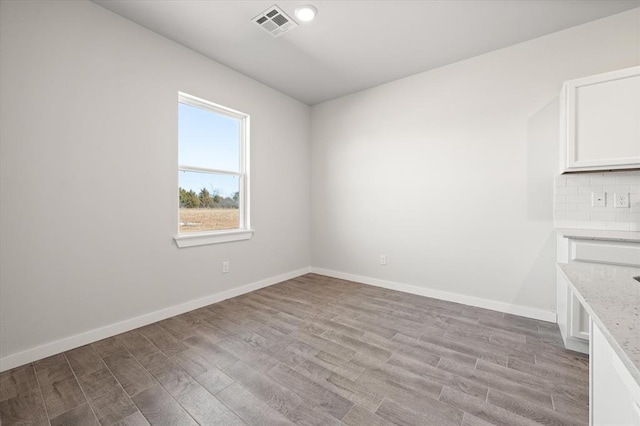 unfurnished room featuring light hardwood / wood-style floors