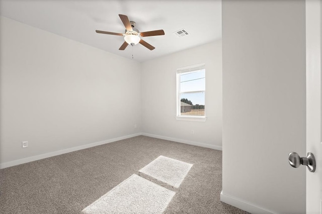 carpeted spare room with ceiling fan