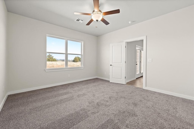 spare room featuring carpet flooring and ceiling fan